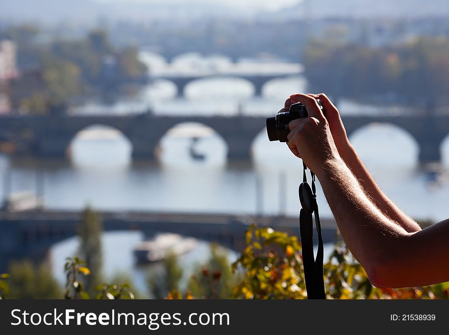 Tourist Taking picture of The Charles Bridge  and Vltava river in Prague. Tourist Taking picture of The Charles Bridge  and Vltava river in Prague