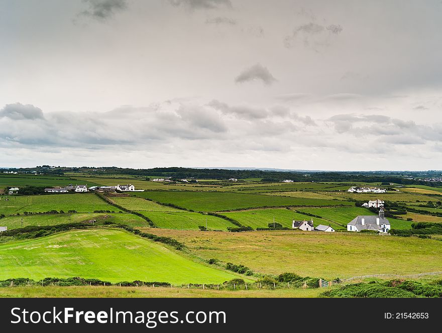 Typical Irish landscape, with shmall houses and green grass. Typical Irish landscape, with shmall houses and green grass.