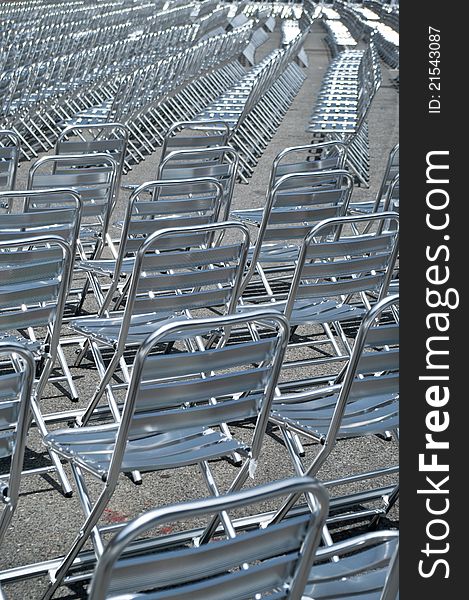 Empty metal chairs lined up for before show.