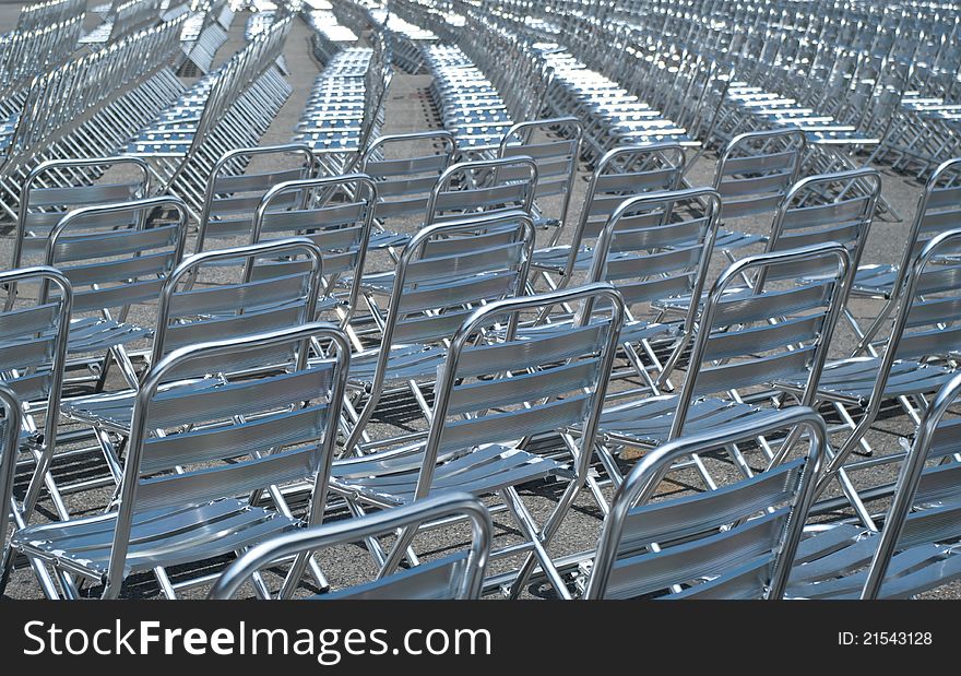 Empty metal chairs lined up for before show.