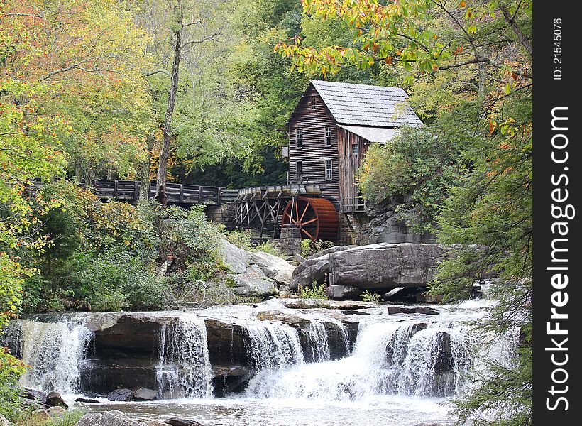 An old grist mill along a stream with water falls. An old grist mill along a stream with water falls