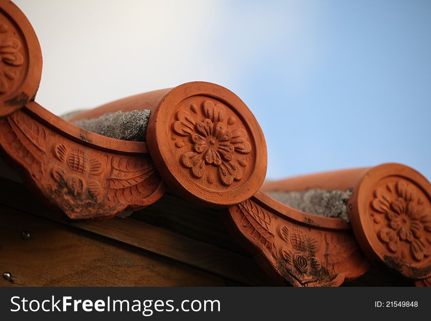 Ornate looking clay Asian roof tile.