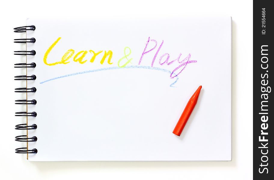 Note book with learn and play text over white background