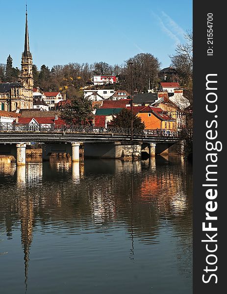 The city of Montbeliard, France. Reflection in the river by a clear and sunny morning.