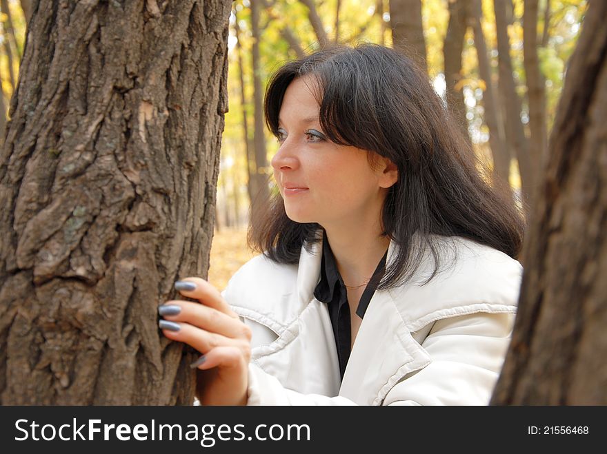 Portrait of woman among the trees in autumn. Portrait of woman among the trees in autumn