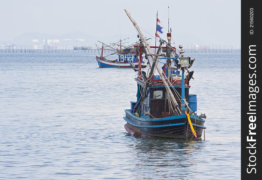 Fishing boat in the sea on blue sky background