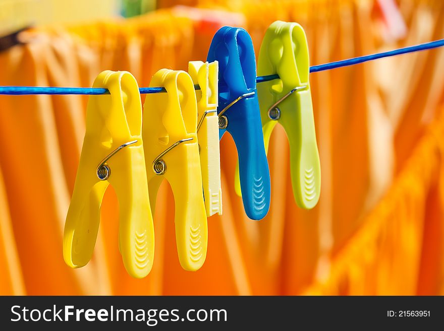 Washed clothes drying outside with cloth pegs