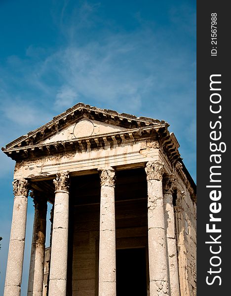 Small roman temple in the Croatian town of Pula with blue background