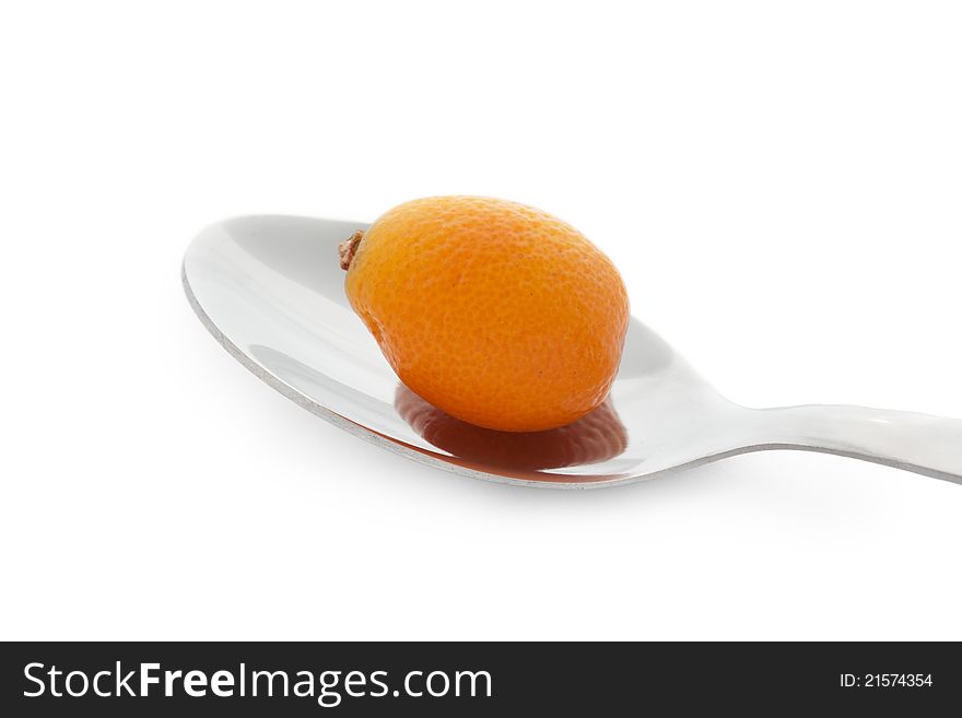 Kumquat on steel spoon on white background