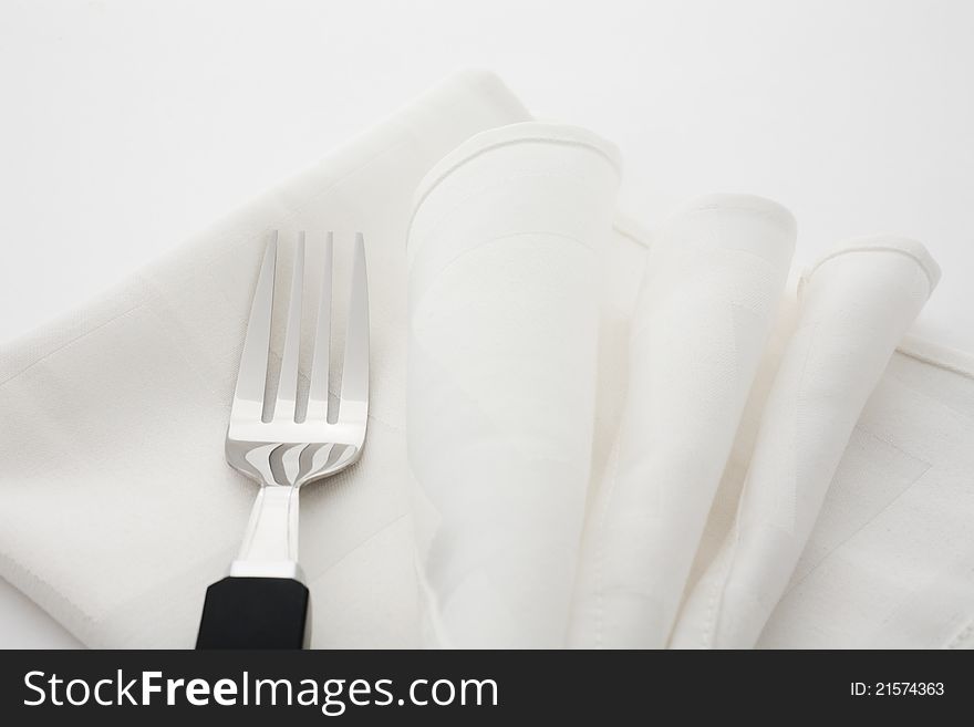 Fork and napkin decorated on white background. Fork and napkin decorated on white background