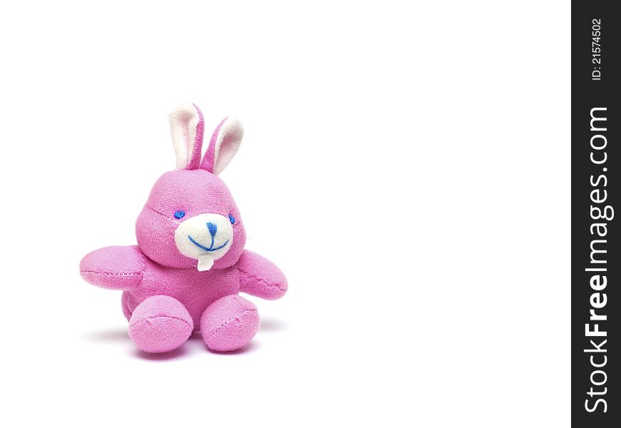 Pink toy rabbit on a white background
