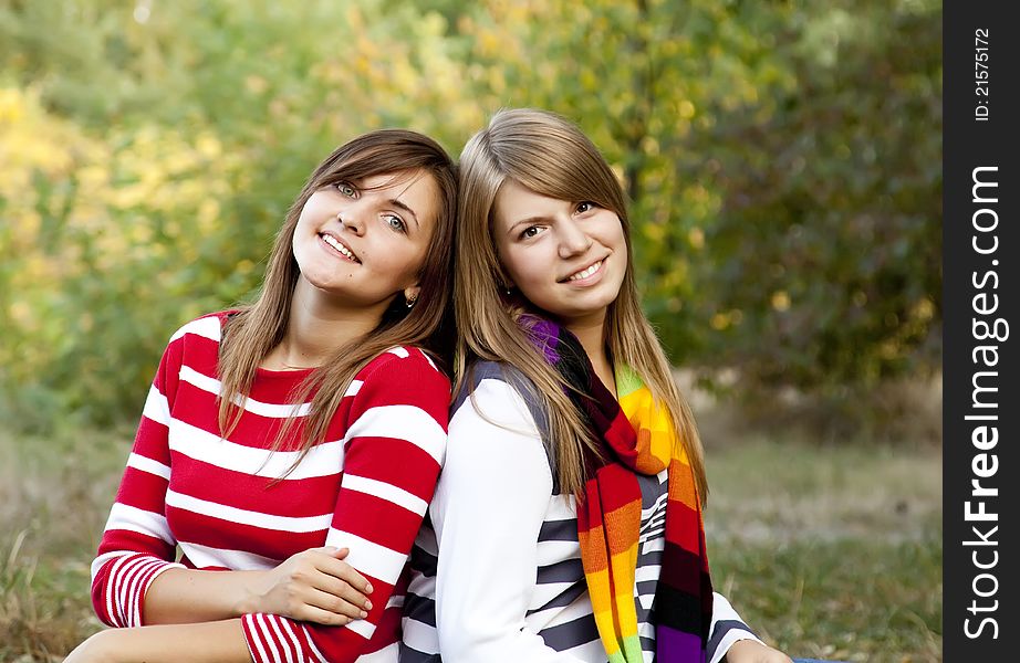 Portrait Of Redhead And Brunette Girls At Outdoor.