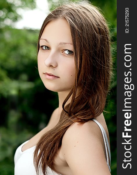 Young woman portrait on green background.