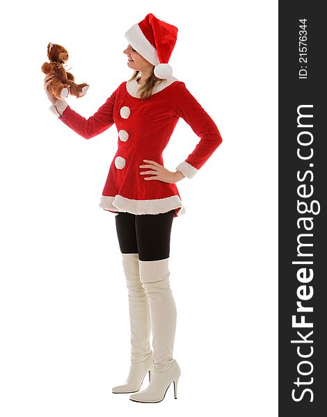 Santa's helper holding a teddy bear and talking with the toy. Santa's helper holding a teddy bear and talking with the toy