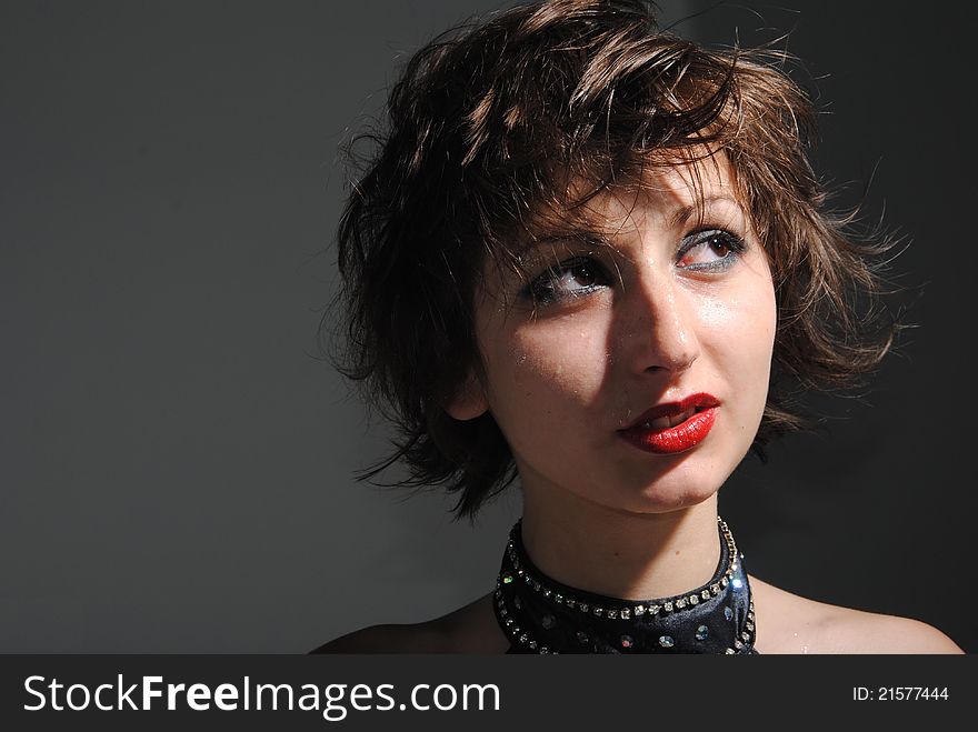 Portrait of girl with short long hair on a grey background