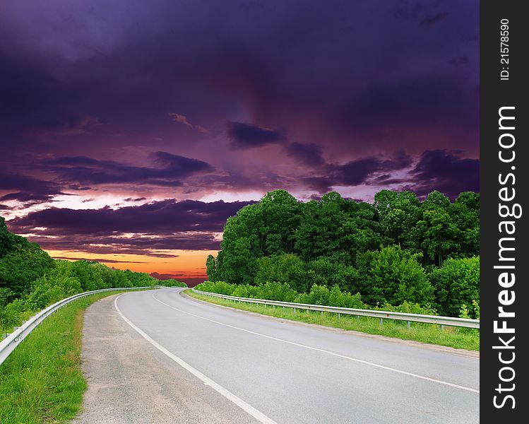 Empty road with cloudy sky and sunlight