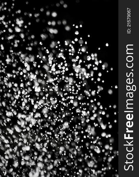 White water droplets on a black background.
