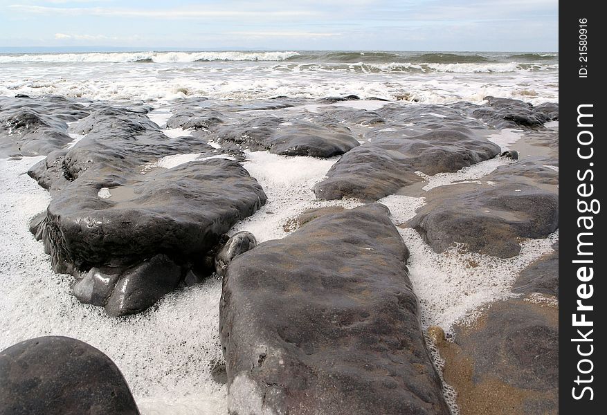 Rocks on Trecco Bay in Porthcawl as the tide comes in. Rocks on Trecco Bay in Porthcawl as the tide comes in.