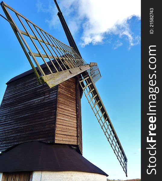 Image of a windmill in the country with blue sky in the background