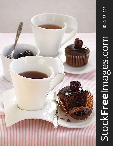 Breakfast with a cup of tea and fresh chocolate cup cakes. Breakfast with a cup of tea and fresh chocolate cup cakes