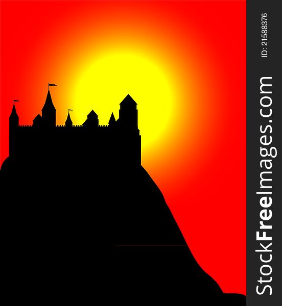 Black silhouette of the castle on a high hill at sunset
