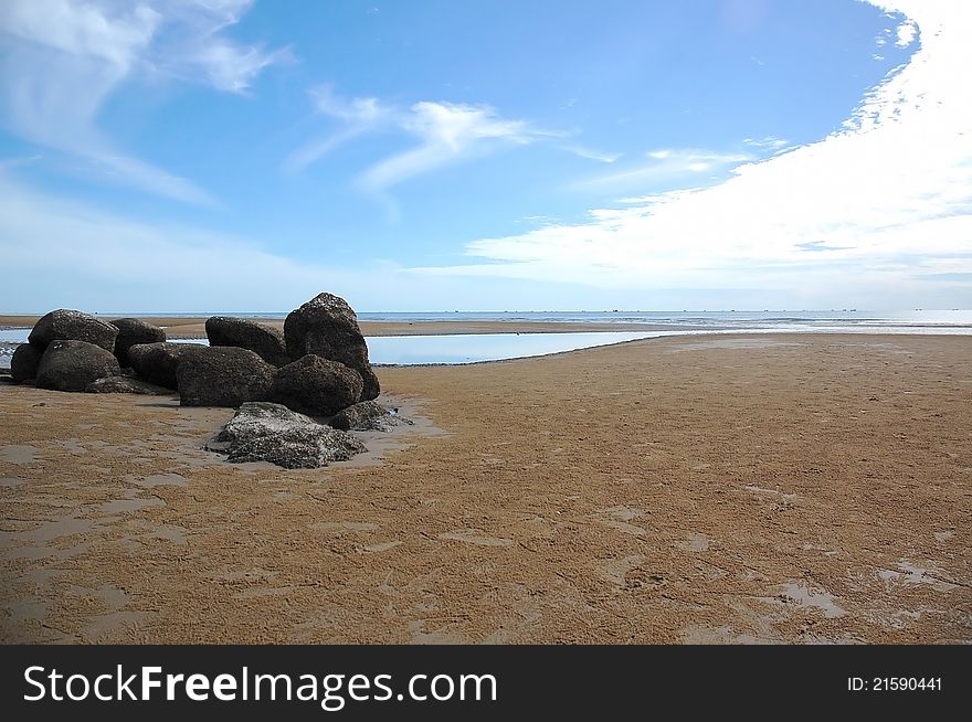 Curve of sky and seascape with black natural stone on beach at Thailand. Curve of sky and seascape with black natural stone on beach at Thailand