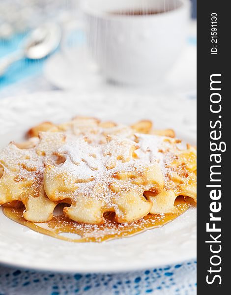 Christmas Snowflake Pancakes with maple syrup and icing sugar
