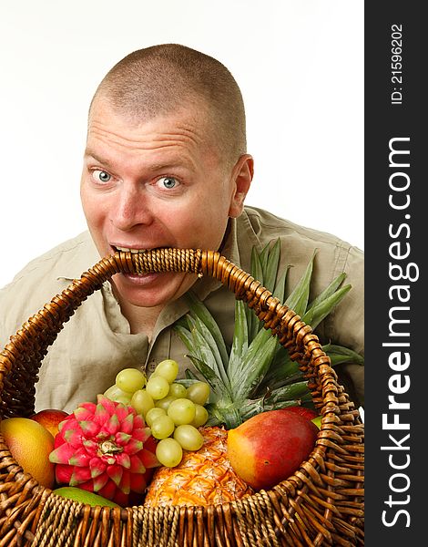 Man with a cane basket of fruit in the mouth. Man with a cane basket of fruit in the mouth