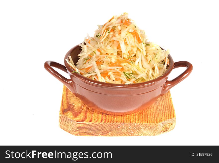 The pot with cabbage costs on a wooden board. The pot with cabbage costs on a wooden board