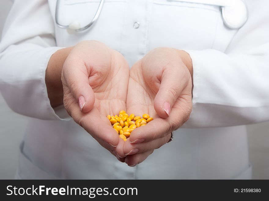 Doctor holding a handful of pills.