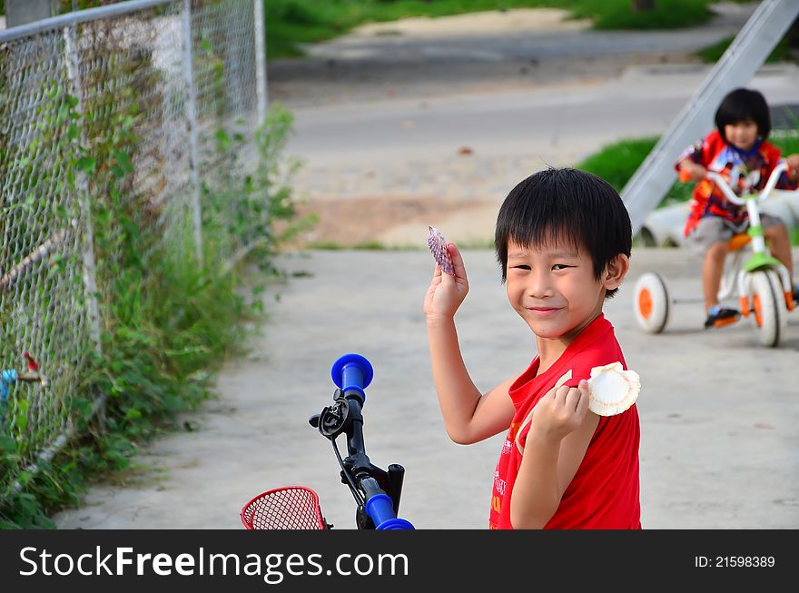 Happy Asian Boy Showing His  Shell In His Arms