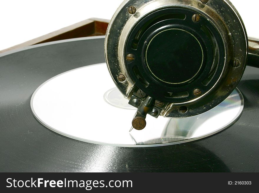 Compact disc put on vintage record together with gramophone head. Compact disc put on vintage record together with gramophone head