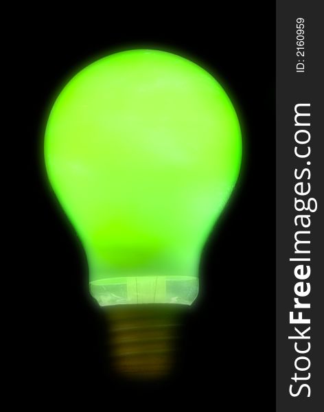 Blurry green lightbulb isolated on a black background
