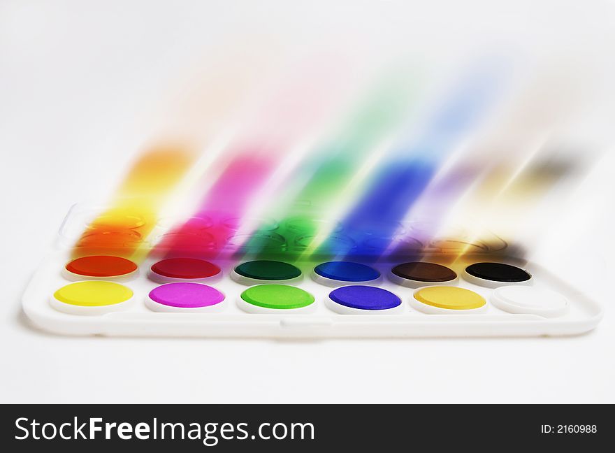 A painter�s palette with water colors in blur motion. A painter�s palette with water colors in blur motion