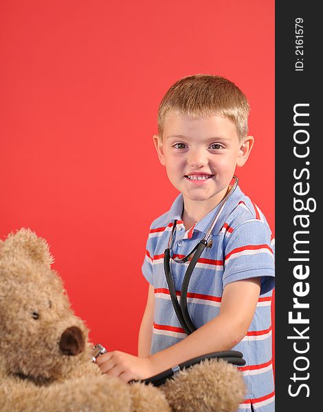 Shot of a little boy checking bears heartbeat vertical. Shot of a little boy checking bears heartbeat vertical