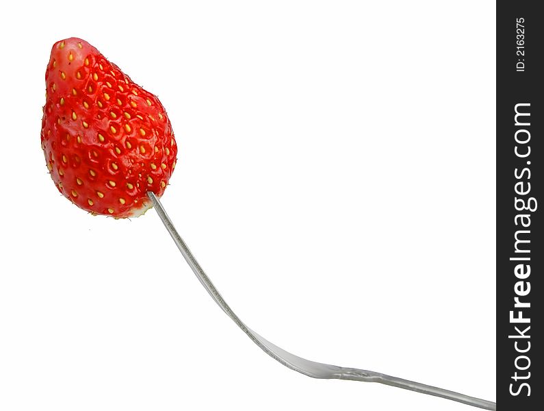 Strawberry in fork isolated over white background.