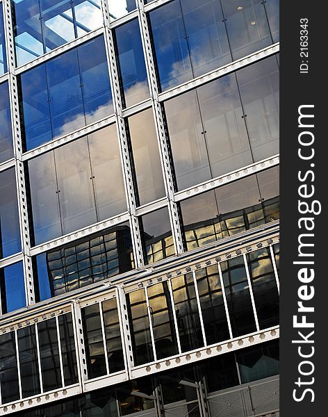 Reflections of clouds in a glass office building. Reflections of clouds in a glass office building.