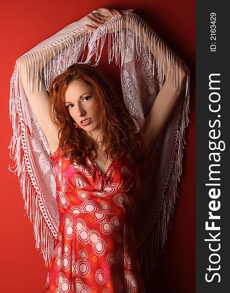 Beautiful red hair woman in red dress with white scarf. Beautiful red hair woman in red dress with white scarf