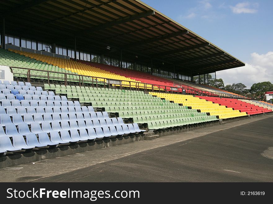 Many Empty Seats In Rows In An Outdoor Stadium. Many Empty Seats In Rows In An Outdoor Stadium