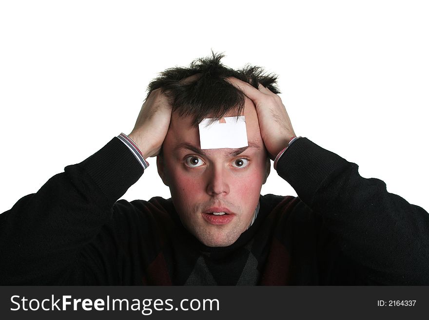 Young man with crazy eyes and blank piece of paper on his forehead. Young man with crazy eyes and blank piece of paper on his forehead