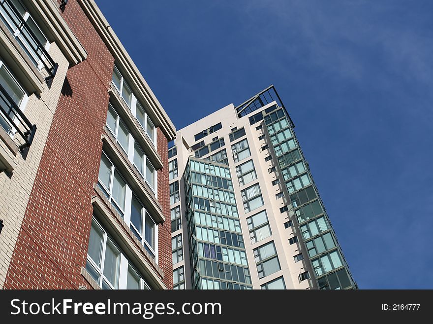 Two new condominium developments with a vivid blue sky in the background. Two new condominium developments with a vivid blue sky in the background.