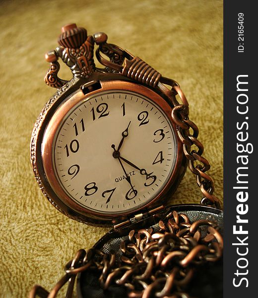 Close-up of old golden clock on vintage background