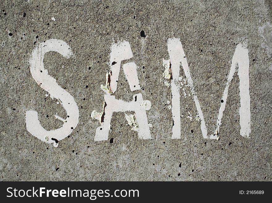 A concrete wall with Sam written on it. A concrete wall with Sam written on it