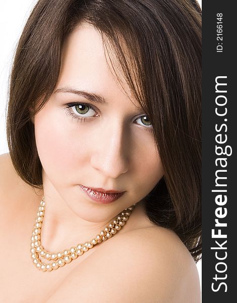 Portrait of the beautiful girl with a beads on a neck over white background. Portrait of the beautiful girl with a beads on a neck over white background