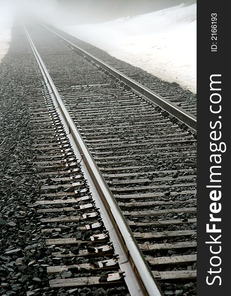 Abstract of rural railroad tracks with snow and fog. Abstract of rural railroad tracks with snow and fog