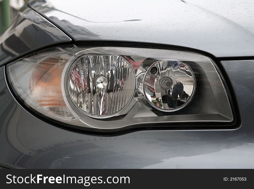 Head lights of a sport grey car