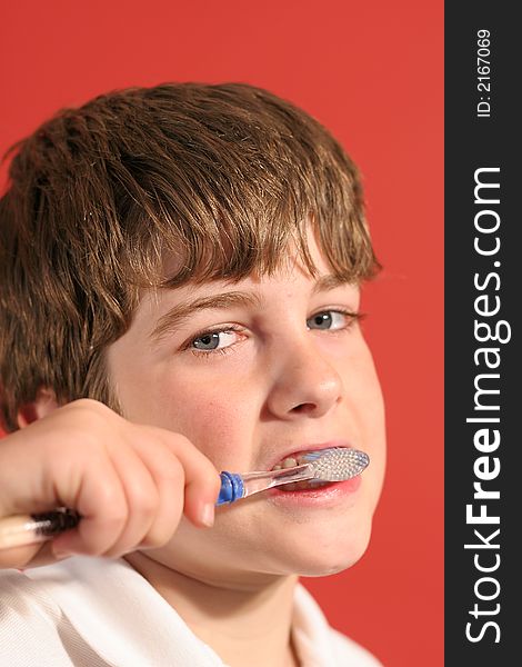 Shot of a boy brushing teeth vertical upclose
