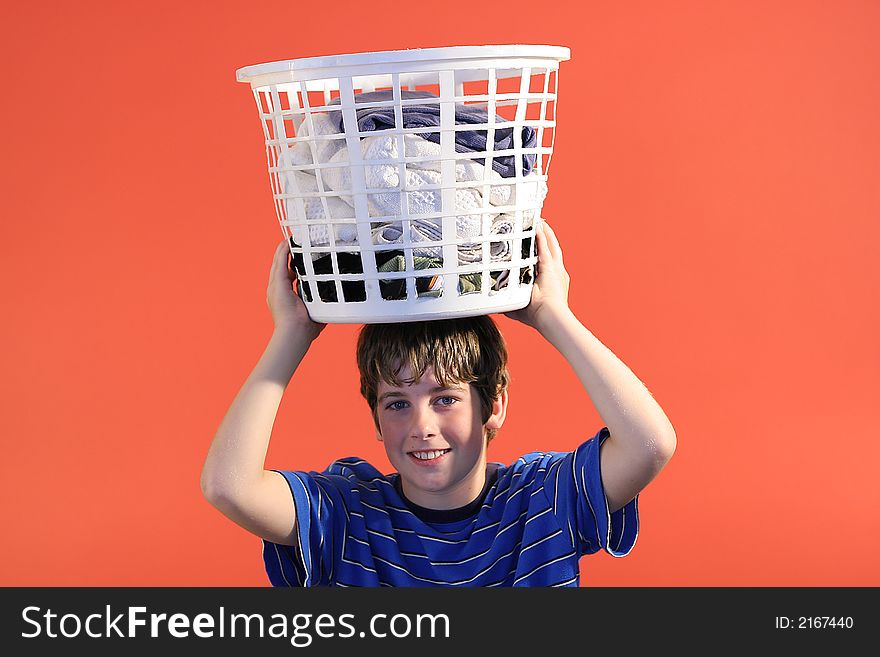 Photo of a boy with laundry basket on head. Photo of a boy with laundry basket on head