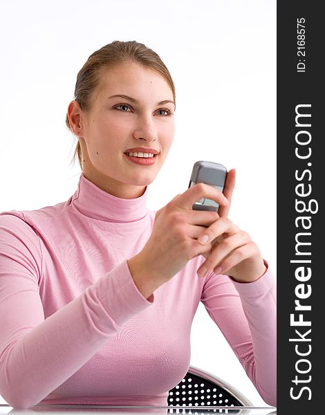 Young woman is looking straight forward while holding her cell phone. Young woman is looking straight forward while holding her cell phone