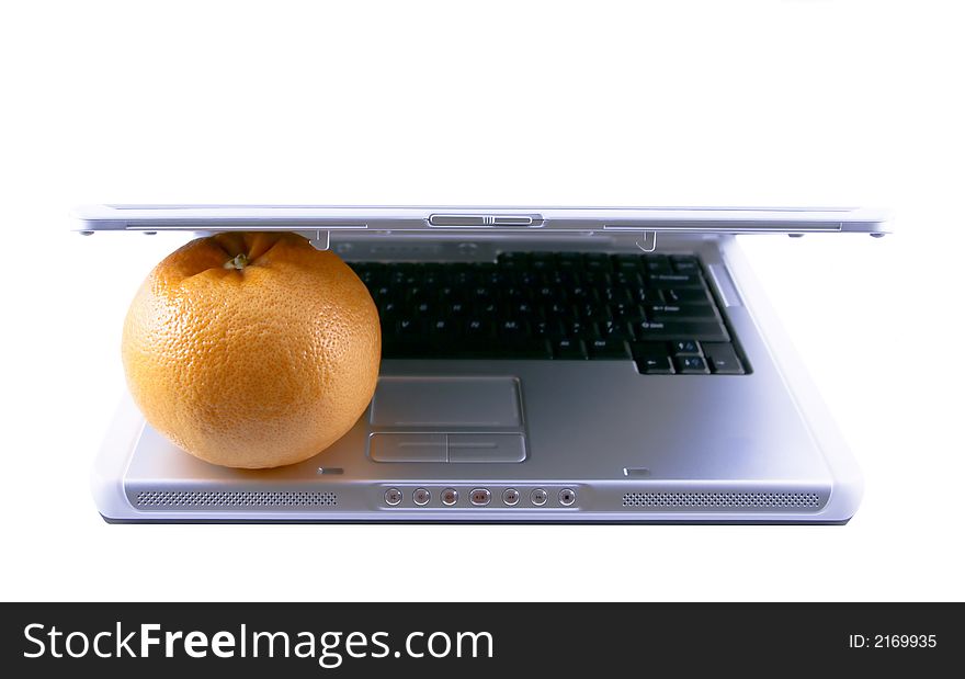 Laptop and grapefruit selected on a white background